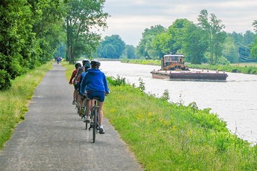 people riding bicycles near a body of water