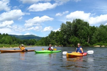 a group of people in a kayak in a body of water