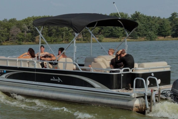 a group of people in a small boat in a body of water