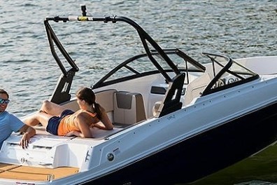 a man and woman sitting on a boat in a body of water